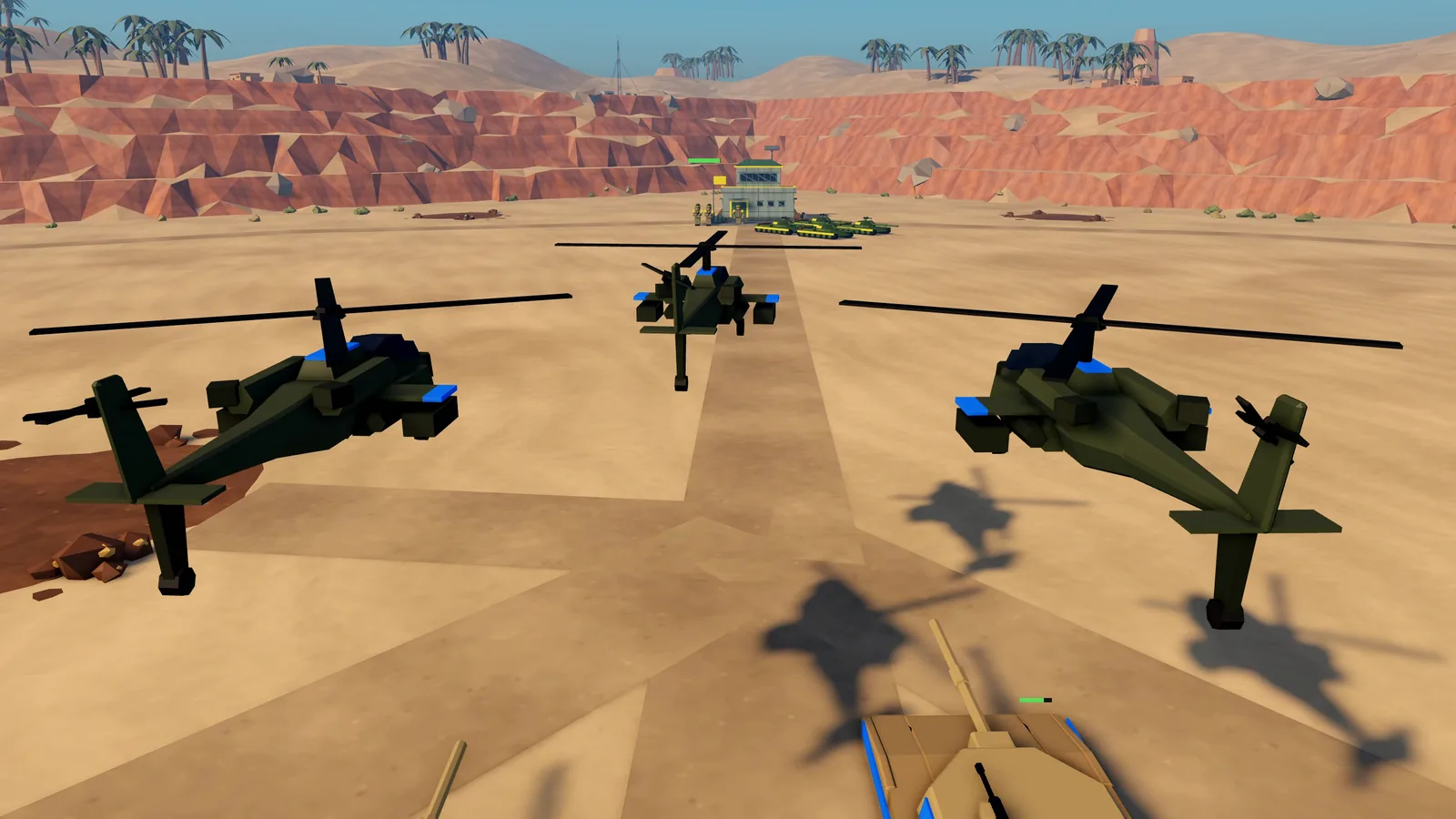 AH-64 attack helicopters lift off over the desert